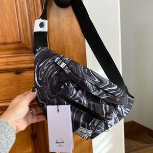 Never used Herschel Fanny Pack black with swirl print.